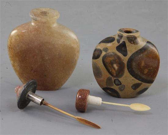 A Chinese pudding stone snuff bottle and a Chinese crystal snuff bottle, 19th century, 6.4cm and 7.7cm incl. stoppers